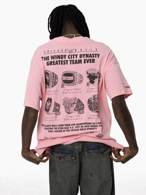 Back movement view of Bulls Dynasty Pink Tee featuring an oversized fit, bold text design, and championship rings on back.