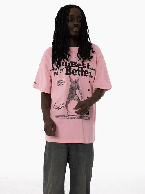 Dennis Rodman Bulls Dynasty Pink Tee movement shot featuring a relaxed fit, bold text design, and player graphic on front.